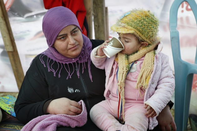 Mariam-Abu-Madegham-Al-Turi-sits-with-her-niece-in-her-familys-tent.-629x419